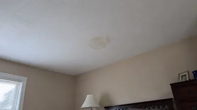 A ceiling water stain, an early sign of a roof leak, in a Milwaukee home