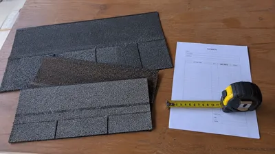 Asphalt shingle samples and a roof replacement cost estimate for a Milwaukee home