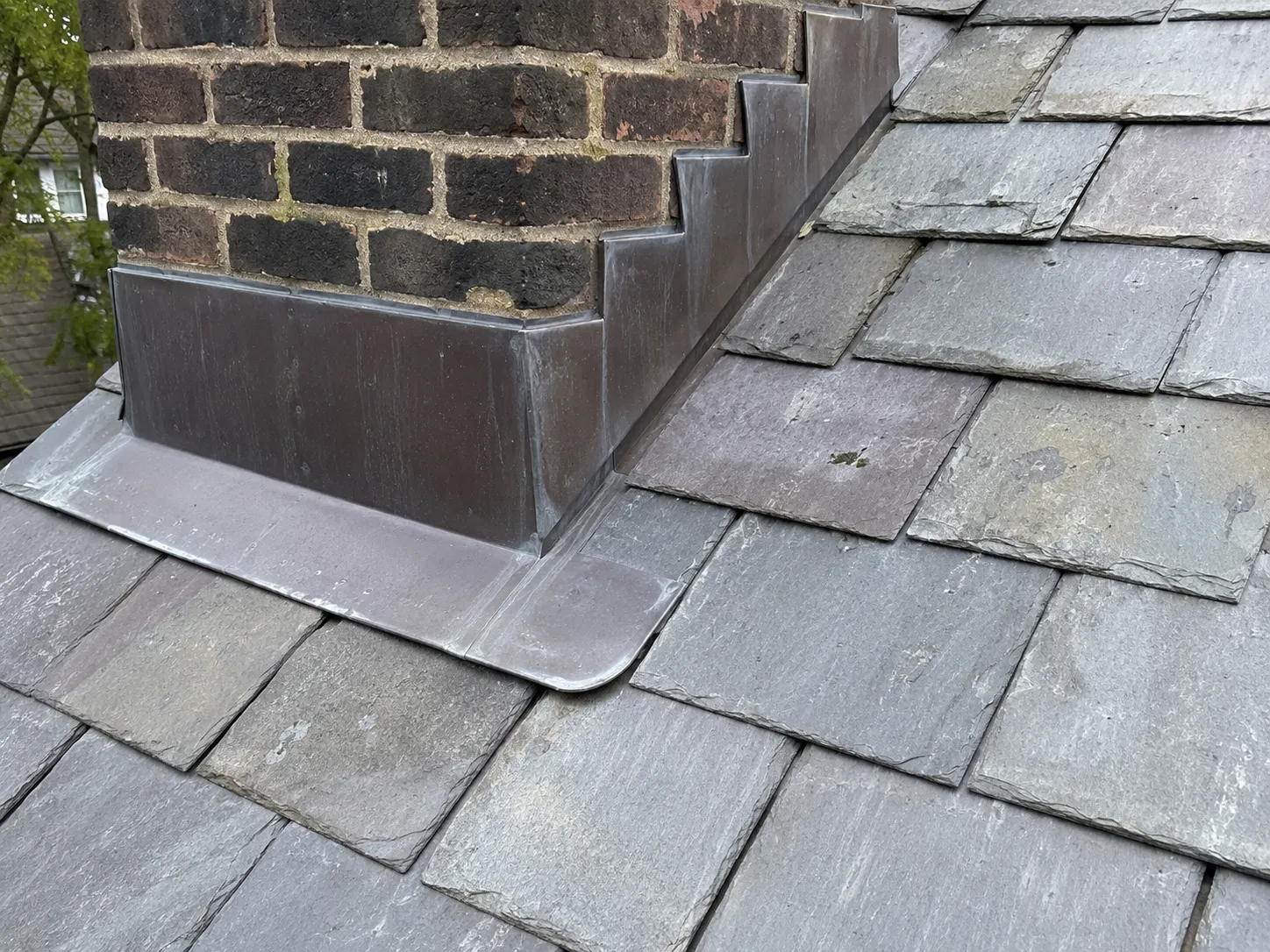 Flashing detail around a chimney on a Milwaukee slate roof